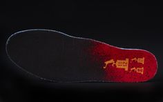 the sole of a skateboard on a black background