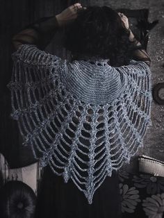 a woman wearing a blue crochet shawl