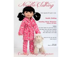 the doll is wearing pajamas and holding a sheep