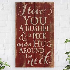 a wooden sign that says i love you, bushel and a peck and a hug around the neck