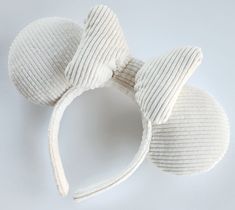 Ears Inspired by the Mouse! Soft Ivory Corduroy Mouse Ears.  ▫️ These simple ears pair great with outfits inspired by some of your favorite characters and are perfect for any day at the parks! ▫️ Rubber Headband Comb comes with every pair of ears. Combs are peel and stick. Hot glue can be added for stability ▫️Headband, ears, and bow are all sewn. ▫️Ears and bow are also sewn to the headband.  ▫️ Made of a soft thin ribbed Corduroy.  ▫️ Bow is filled with Polyester fill.  ▫️ Ears are formed with quality foam and filled with Polyester fill.  ▫️Thickness of bow and ears my vary slightly.  ▫️Contact me with any questions.  ▫️Custom orders are accepted.   ▫️Ships free within the US. Custom Disney Ears, Cold Disney Outfits, Aesthetic Presents, Micky Ears, Disney Gear, Disney Fits, Disney Ears Headband, Disney Honeymoon, Disney Themed Outfits