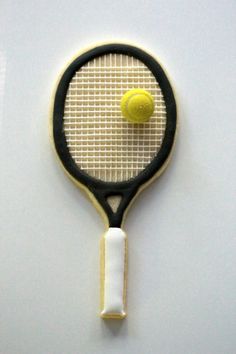 a tennis racket and ball are made out of cookie dough on a white surface