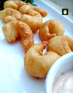 fried doughnuts and dip on a white plate