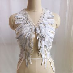 a mannequin with white wings on it