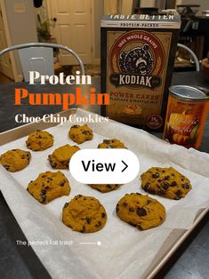 chocolate chip cookies on a baking sheet next to a box of kodak protein pumpkin