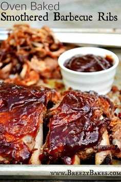 barbecue ribs with bbq sauce on the side and another dish in the back ground