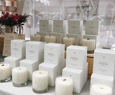 many candles are on the table in front of some boxes