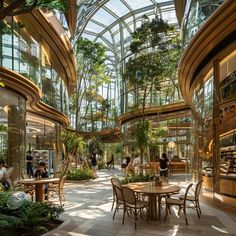 the inside of a building with many plants and people sitting at tables in front of them