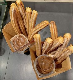 several churros with dipping sauce in small bowls