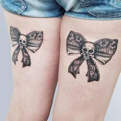 two tattoos with bows and skulls on their legs, one has a skull in the middle