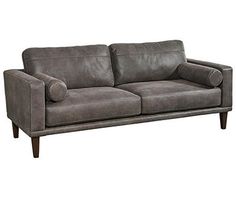 a gray couch with two pillows on it