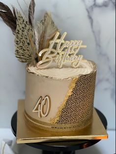 a birthday cake decorated with feathers and the number forty