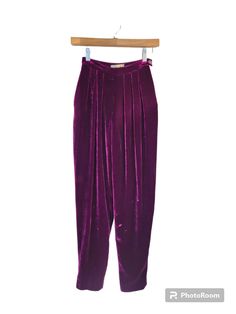 "Luxurious real velvet pants in rich plum color. So many decadent details, including:  * Full hips, tapered ankle * High waisted * Front pleats * Side zipper, with two waist buttons * Fully lined * Side pockets! Label: Liz Claiborne Petite Era: 1980s Fabric: 82% rayon, 16% silk. Lining 51% acetate, 49% nylon Condition: Excellent. Faint marks on legs, as displayed in photos. Hard to see except under close examination. **All SSV garments are lovingly laundered by Shop Owners Karyn and Kelsey before going out for sale. Many, including this one, are professionally restored by Shop Seamstress Brinkley. For more information about how to care for your vintage garment, an explanation of Vintage Conditions, and our restoration process, please see the \"FAQs\" and \"About\" page.** Modern Size: Extr Formal Full-length Purple Bottoms, Purple Formal Full-length Bottoms, Purple Full Length Formal Bottoms, Full Length Purple Formal Bottoms, Fall Velvet Trousers, Elegant Purple Straight Leg Bottoms, Burgundy Wide Leg Pants For Party, Elegant Full-length Purple Bottoms, Elegant Full Length Purple Bottoms