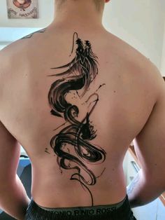 a man with a dragon tattoo on his back