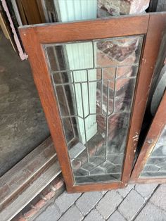 an old wooden door with glass panels on the front and side doors are broken open