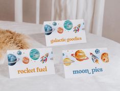 there are three cards that say rocket fuel, rocket fuel and moon pies on the table