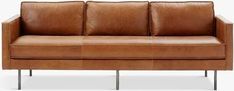 a brown leather couch sitting on top of a metal frame