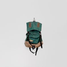 a green backpack hanging from the ceiling