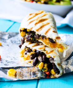 two quesadillas stacked on top of each other with black beans and corn