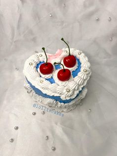 a heart shaped cake with cherries on top