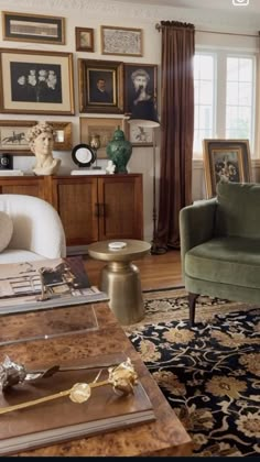 a living room filled with furniture and pictures on the wall