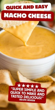 a hand holding a tortilla chip over a bowl of nacho cheese