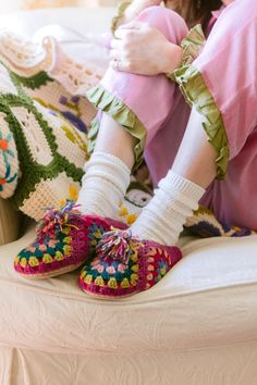 Brightly hand-dyed yarn, hand-felted and crocheted with granny squares. These slippers are sure to keep your feet stylish, warm, and happy all season long. 100% wool with leather sole. Sold in sizes XS (6-6.5), S (7-7.5), M (8-8.5), L (8.5-9), XL (10-10.5). Roomy, size down. We know slippers are bit trickier to fit than our knit hats so we are offering free exchanges to find your perfect pair. Crochet Shoe Accessories, Pink Granny Square, Granny Square Slippers, Crocheted Slippers, Square Shoes, Granny Square Crochet Patterns Free, Crochet Slipper Pattern, Crochet Leaves, Crochet Daisy