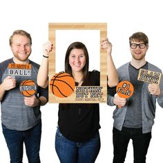 three people holding up signs with basketballs on them