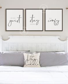 three framed art prints hanging on the wall above a bed with pillows and striped pillow