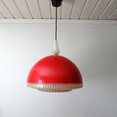 a red light hanging from a ceiling in a room