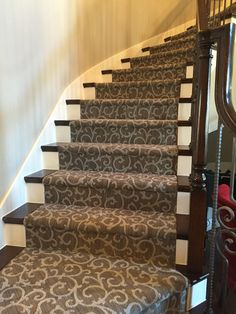 a staircase with carpeted steps and handrails