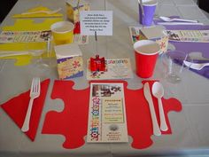 the table is set up for a children's birthday party with paper plates, cups and utensils