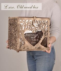 a woman is holding a metal box with a heart in it and the words brenn's sala written on it