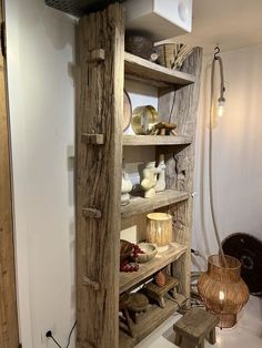 a wooden shelf filled with lots of items