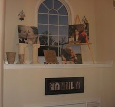 there is a window above the mantle with pictures on it