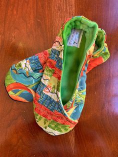 a pair of colorful shoes sitting on top of a wooden floor