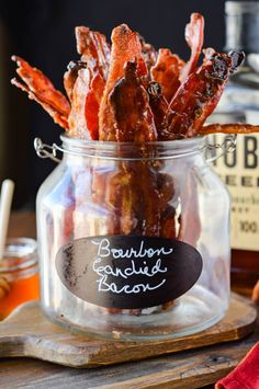 bacon in a glass jar with a chalkboard label on the bottom and labels below it