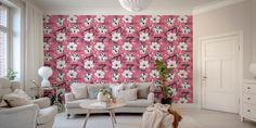 a living room with pink and white wallpaper, two couches and a coffee table