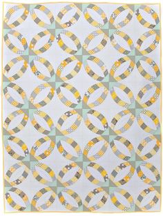 a quilt with yellow and grey circles on it