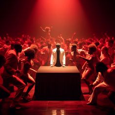 a man standing on top of a table surrounded by dancers