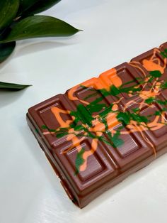 a chocolate bar with green leaves on it