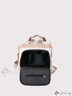 a white and black backpack with gold trimmings on the front, side view