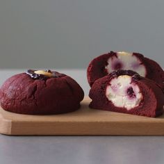 two red velvet desserts on a wooden cutting board