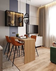 a living room filled with furniture and a flat screen tv on top of a wooden table