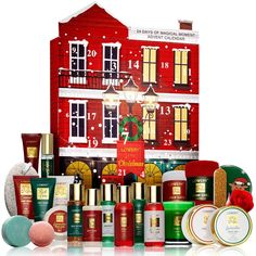 an assortment of beauty products displayed in front of a red building with snowflakes on it