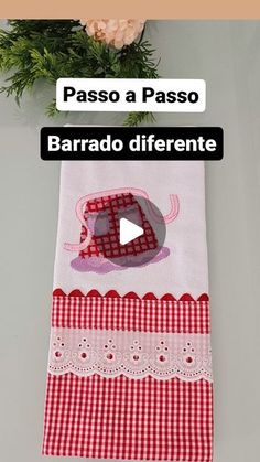 a red and white checkered table runner next to a vase with flowers on it