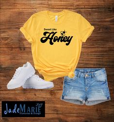 a t - shirt that says sweet like honey next to shorts and sneakers