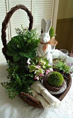 a basket filled with flowers and plants on top of a table