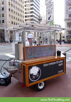 an outdoor food cart on the side of the road