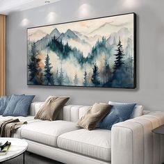 a living room filled with furniture and a painting hanging on the wall over a white couch